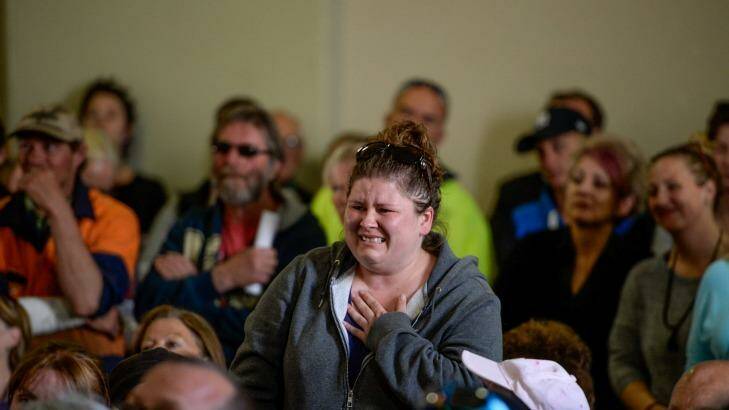 An emotional woman inquires about the status of her house and pets at a community meeting in Lancefield. Photo: Justin McManus 