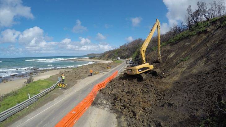 Soil works are carried out along the Great Ocean Road at Wye River. The road has been closed after landslides.  Photo: Joe Armao