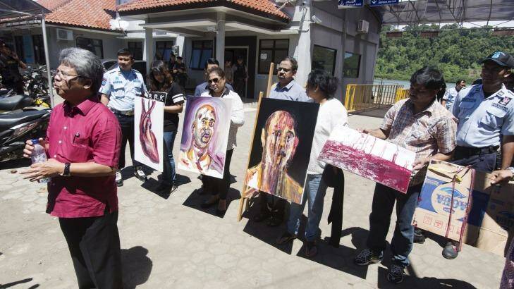 Paintings by Myuran Sukumaran, and signed by all nine awaiting execution are displayed by Sukumaran's family at Wijaya Pura in Cilacap on the day of the execution.  Photo: James Brickwood