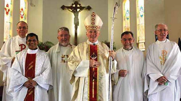 Bishop Les Tomlinson (fourth from left) with Joseph Doyle (far right), photographed more than five years after the Melbourne Response ordered Doyle to stop acting as a priest. Photo: supplied