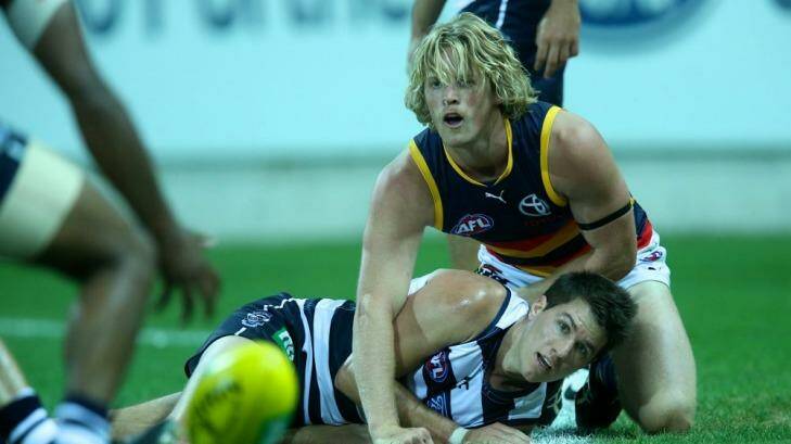 Andrew Mackie has eyes only for the ball as Rory Sloane of the Crows watches on. Photo: Pat Scala