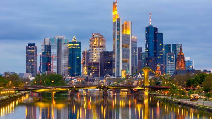 Looking down the River Main at the skyline of Frankfurt at dusk, Hessen, Germany.