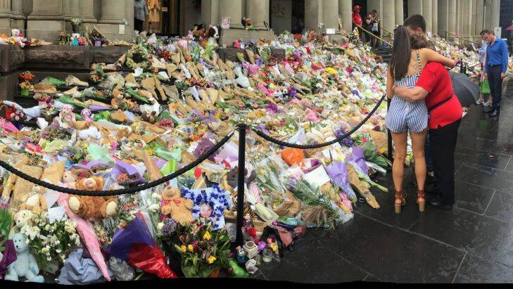 Crowds still gather at the floral tribute memorial commemorating the lives of the five people killed during the Bourke Street tragedy . scores of people were mowed down by a car allegedly driven by accused killer Dimitrious Gargasoulas. 30th January 2017. Photo by Jason South