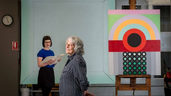 Artist Janet Dawson (front)  and NGV curator Beckett Rozentals, with John Peart's Corner square diagonal (rear) and James Doolin's Artificial landscape 67-6. Photo: Penny Stephens