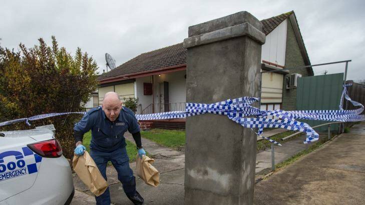 Police carry evidence from the family home in Cohuna Street, Broadmeadows on Wednesday. Photo: Jason South