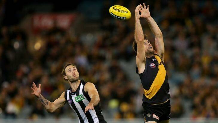 Trent Cotchin attempts to take a mark as Brent Macaffer watches keenly. Photo: Pat Scala