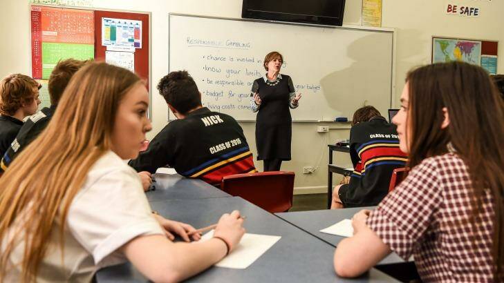 Williamstown High School VCAL students and teacher Anne Goller do the maths on gambling risks. Photo: Justin McManus