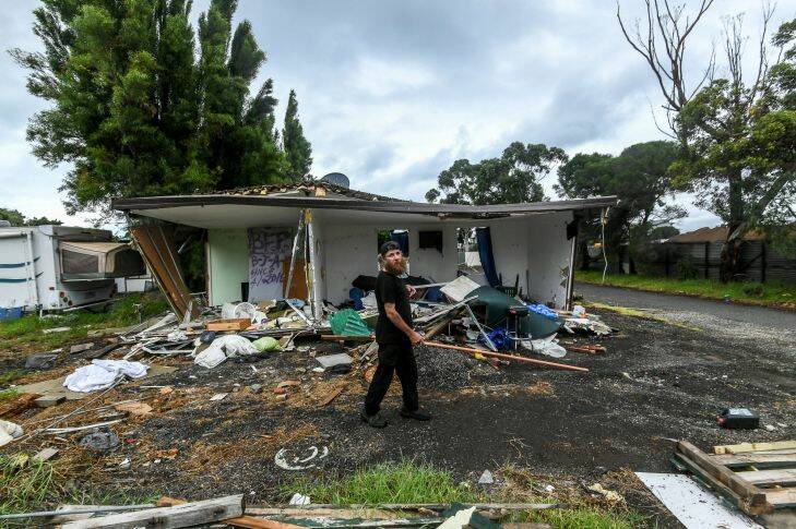 The Age, News 22/03/2017, picture by Justin McManus. Hobsons Bay Caravan park has been sold to developers. It has tradionaly been a last resort refuge for people on low incomes in danger of becoming homeless. Housing services have had to scramble resources to find accomodation for the last of the residents before they are kicked out and become homeless. The park is in the process of being demolshed while resudents are still living there. Resident Michael walking past a van that has been trashed that belonged to his park neighbour. He has been living in the park for nine months. Photo: Justin McManus