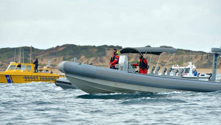 Police and the Coast Guard search for the missing plane crash victim. Photo: Joe Armao