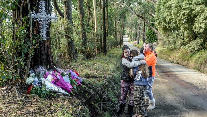Friends comfort each other at the scene of the fatal crash. Photo: Justin McManus