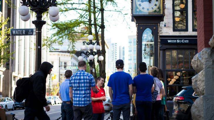 A guide for Vancouver Foodie Tours shows guests the steam clock in Gastown.  Photo: Mark Kinskofer