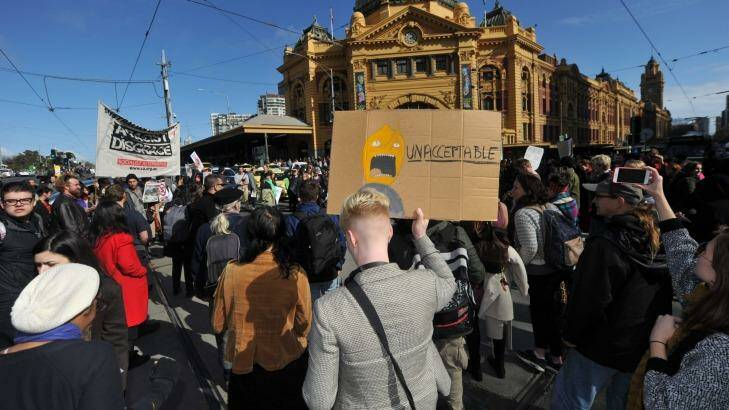 Protesters stop traffic outside Flinders Street Station, protesting against planned border protection raids. Photo: Joe Armao