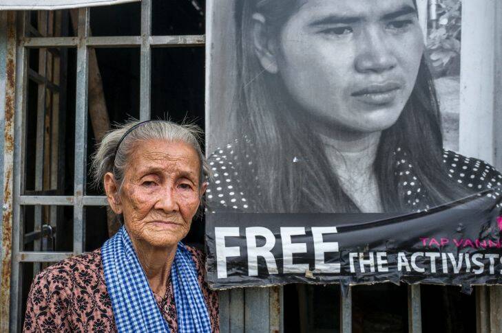 PHNOM PENH, CAMBODIA - SEPTEMBER 04: Boeung Kak Lake activist Nget Khun stands by a poster demanding the freedom of fellow activist Tep Vany at the entrance to her home on September 04, 2017 in Phnom Penh, Cambodia. Since Boeung Kak Lake was leased to a private company in 2007, resulting in the evictions of surrounding communities in 2009, a group of women from the Lake has taken the forefront of the fight for their rights. Although their activism was initially dedicated to saving their homes, they are now some of Cambodia's most well-known, outspoken and fearless activists, becoming an iconic symbol of the fight of human rights and justice in Cambodia. Photo by Omar Havana Omar Havana