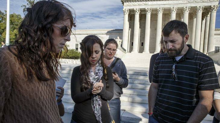 As the Supreme Court begins its new term this week, pro-life advocates hold a prayer vigil on the plaza of the high court in Washington, Saturday, Oct. 4, 2014. The group, Bound 4 Life, has come to the court for ten years to make a silent appeal against abortion.