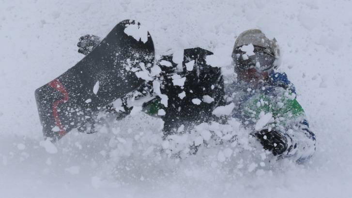 Can you tell the difference? A snowboarder enjoys a flurry on Friday. Photo: Andrew Meares