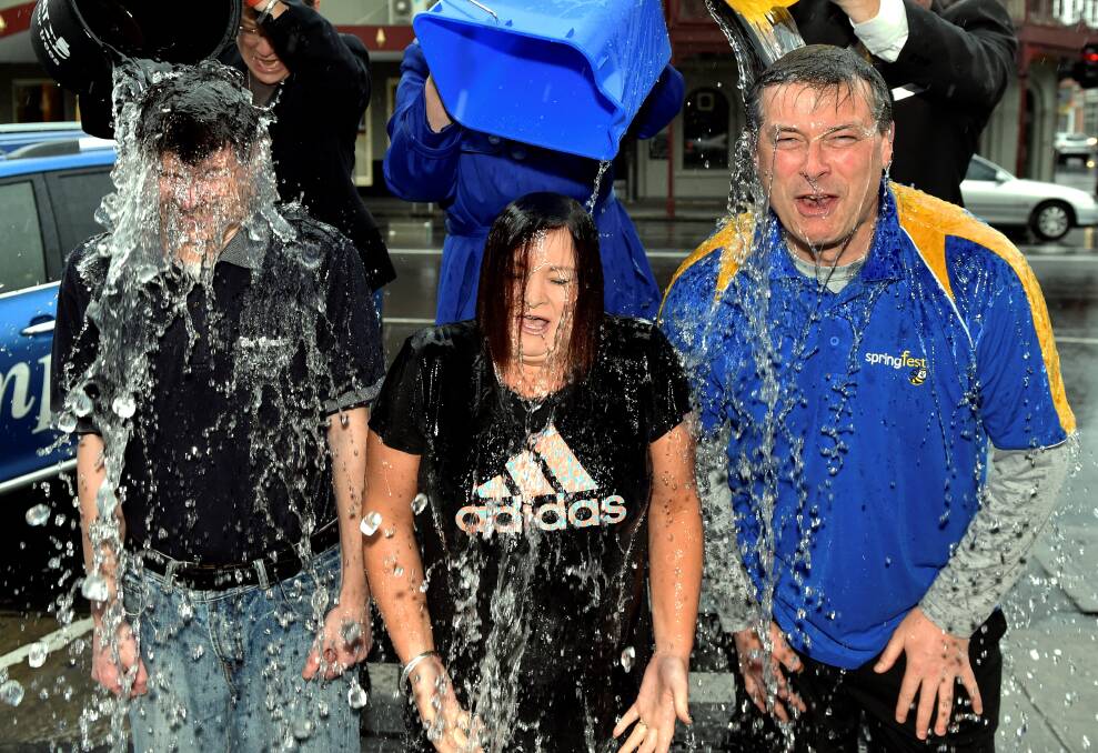 TIPPING A BUCKET: The Courier editor Andrew Eales, Angela Trainor of Simplex Insurance Solutions and Bruce Roberts of WIN TV participate in the ice bucket challenge.