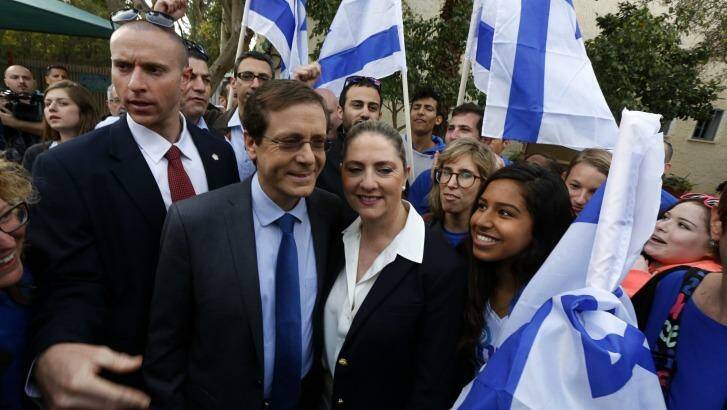 Main contender ... Isaac Herzog (second from left), co-leader of the centre-left Zionist Union party, stands with his wife, Michal, after casting their ballot at a polling station in Tel Aviv. Photo: BAZ RATNER