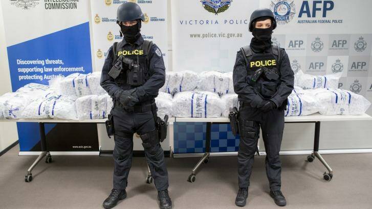 Police stand in front of the seized drugs. Photo: Jason South