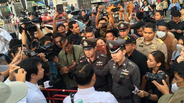 A media scrum forms around senior police at the temple. Photo: Supplied