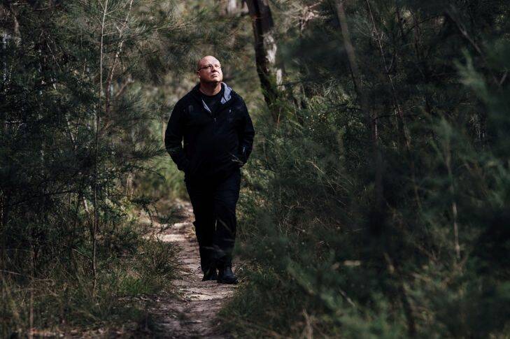 Ricardo Lonza, founder of the Facebook group dedicated to saving the wildife and bushland of Campbelltown, surveys the treetops of St. Helens park for Koalas on Thursday, 31 August 2017. Photo by Cole Bennetts