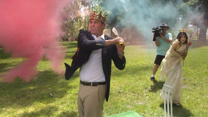 Warnie tries out his crown while hitting some cricket balls filled with coloured powder.  Photo: Simon O'Dwyer SOD