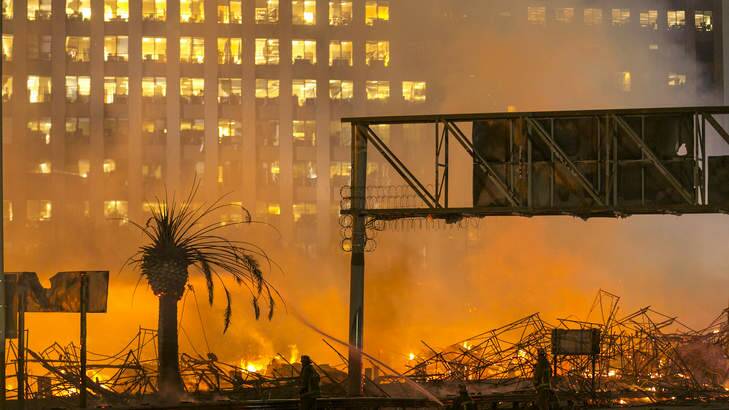 Los Angeles County firefighters battle a fire at an apartment building under construction. Photo: Damian Dovarganes/AP