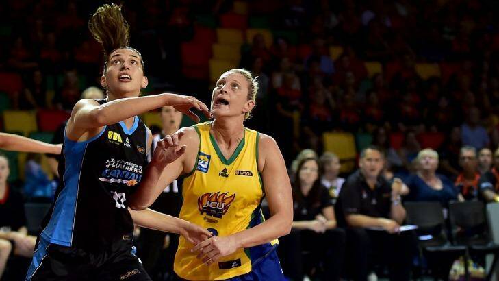 Canberra Capitals skipper Marianna Tolo (left) and Townsville Fire captain Suzy Batkovic battle it out in the WNBL.  Photo: Alix Sweeney (Townsville Bulletin)