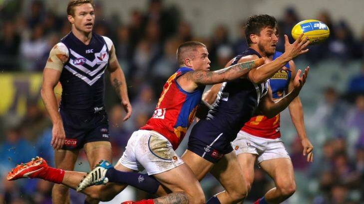 Alex Silvagni of the Dockers gathers the ball against Claye Beams of the Lions on Saturday. Photo: Paul Kane