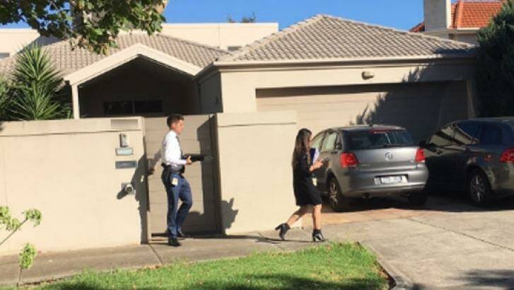 Detectives leave the Ristevski's family home on Tuesday. Photo: Chloe Booker