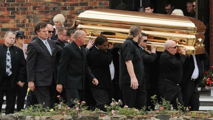 George WiIlliams (far left) watches as  Carl Williams' gold-plated coffin is carried from St Therese's church in Essendon in April 2010.  Photo: Vince Caligiuri