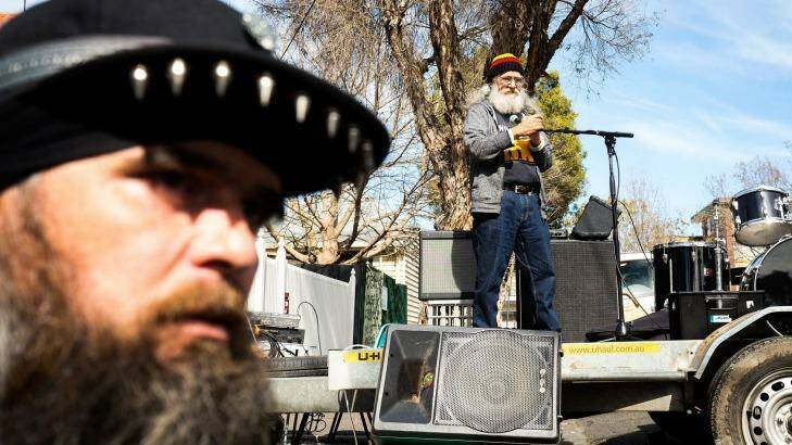 Aboriginal elder Larry Walsh, pictured at the microphone on a truck, called on squatters at the Bendigo Street Festival in Collingwood on Sunday to fight for a more permanent solution to homelessness, particularly among Indigenous people.  Photo: Chris Hopkins