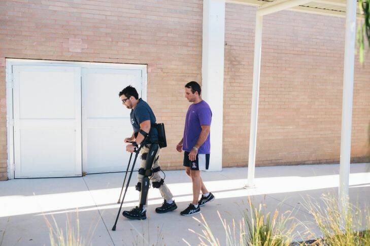 Paraplegic Paul Jenkins learning to walk with bionic legs with exercise physiologist Jim Barrett Photo: Rohan Thomson