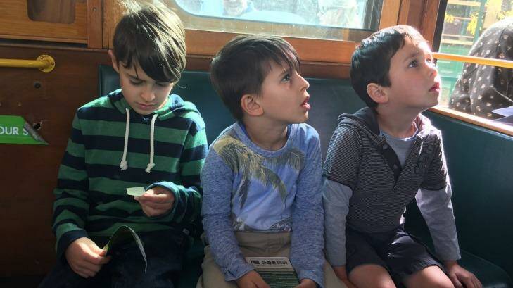 L-R: Christian, Luca and Declan learning about life before Myki. Photo: Hannah Francis