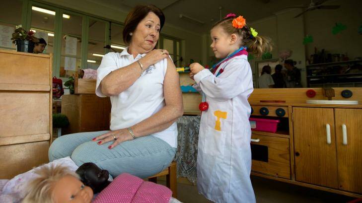 How it's done: Kindergarten co-ordinator Margaret Benincasa receives a pretend immunisation from Maeve Darwin, 4. Photo: Penny Stephens