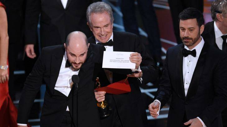 Jordan Horowitz, producer of "La La Land," shows the envelope revealing Moonlight as the true winner of best picture, with Warren Beatty and host Jimmy Kimmel at right. Photo: Chris Pizzello