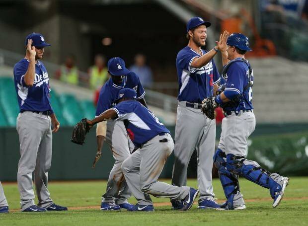 LA dodgers pitcher Clayton Kershaw and teammates celebrate their win. Photo: Anthony Johnson