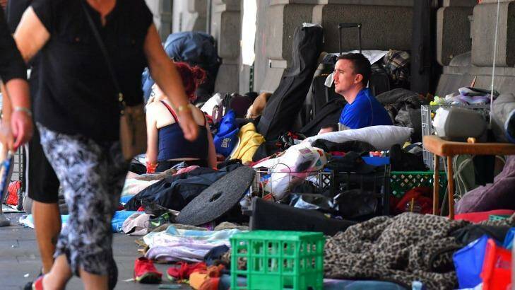 A man sits at the homeless camp outside Flinders Street Station. Photo: Joe Armao