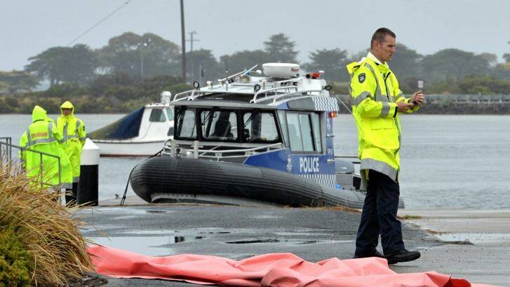 A police boat recovers three bodies after a plane crash at Ocean Grove. Photo: Joe Armao