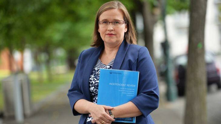 Victorian Equal Opportunity and Human Rights Commissioner Kate Jenkins in 2015 with a copy of the review of sexual harassment in the police force.  Photo: Joe Armao