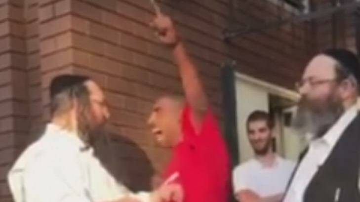 The man in red shirt screaming 'go back to Israel' at a Jewish man outside the Adass Israel synagogue in Ripponlea. 