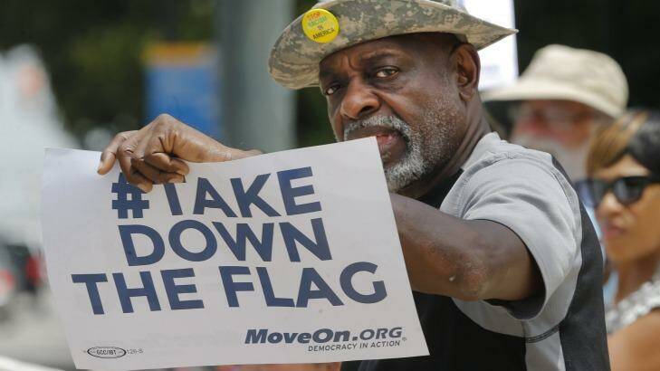 A protester against the Confederate flag, Theron Foster, of Columbia, gives a clear message outside the South Carolina state house. Photo: John Bazemore