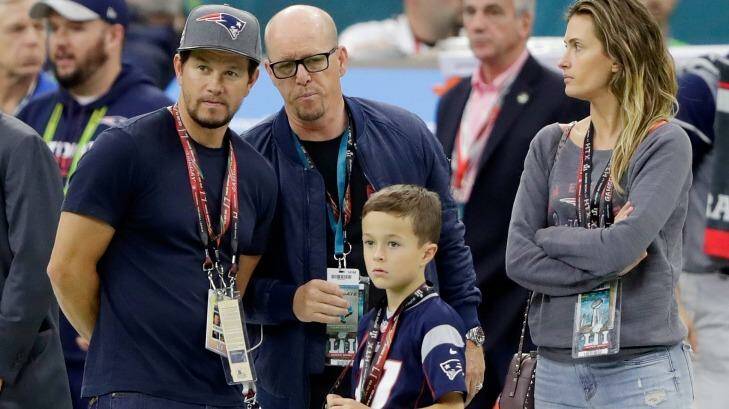 Mark Wahlberg and wife Rhea Durham with their son in the stadium pre-game. Photo: Jamie Squire