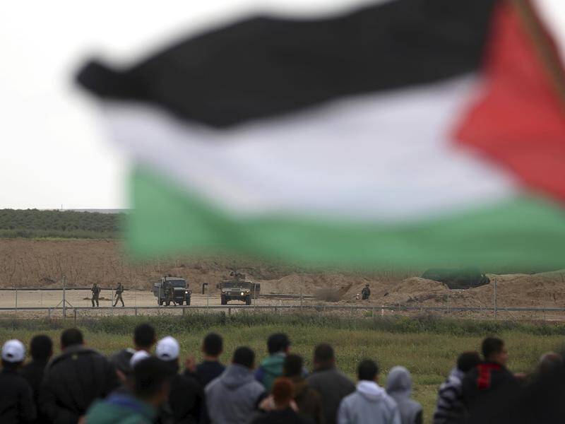 Dozens of Palestinians are clashing with Israeli troops on the Gaza border in protests.