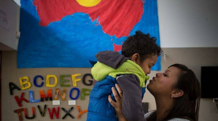 Djural Aldridge, 3, gets a kiss from mum Casey Tennyson at the Bubup Wilam Aboriginal child and family centre. Photo: Jason South