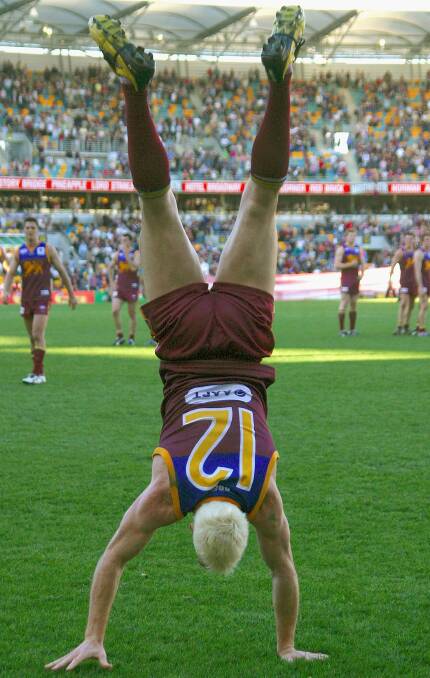 STANDING OUT: It s not showing off if you back it up as Jason Akermanis used to do, celebrating a Lions victory with a handstand. PICTURE: GETTY IMAGES 
 during the round 19 AFL match between the Brisbane Lions and the Hawthorn Hawks at the Gabba on August 7, in 2005. in Brisbane, Australia. (Photo by Bradley Kanaris/Getty Images) *** Local Caption *** Jason Akermanis