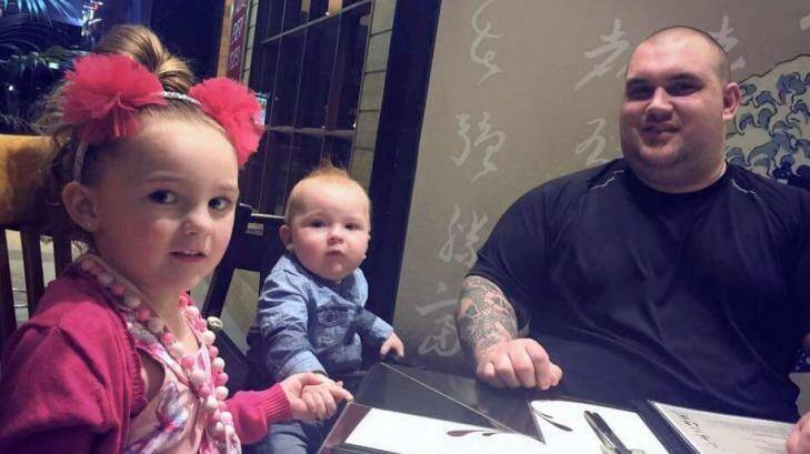  Mitch Jackson is one of the Good Samaritans who went into the burning Springvale Commonwealth Bank to help rescue people. With his children, Ava, 6, and Kai, 2. Photo: Supplied