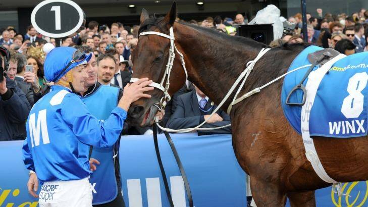 She's back: Hugh Bowman gives Winx a pat after her second Cox Plate victory. Photo: Vince Caligiuri