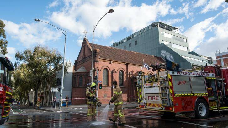Firefighters clean up Victoria Parade. Photo: Penny Stephens