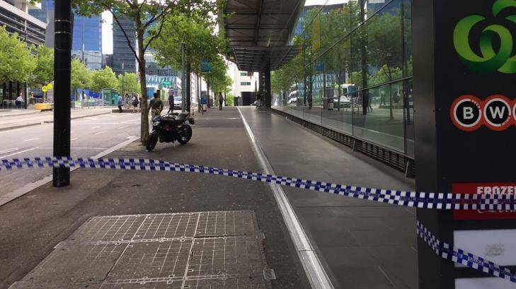 Police tape outside a Woolworths supermarket in Collins Street. Photo: Lia Timson