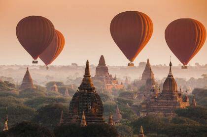 Hot air balloons float over the plain of Bagan on a misty morning in Myanmar. Photo: Noppakun Wiropart